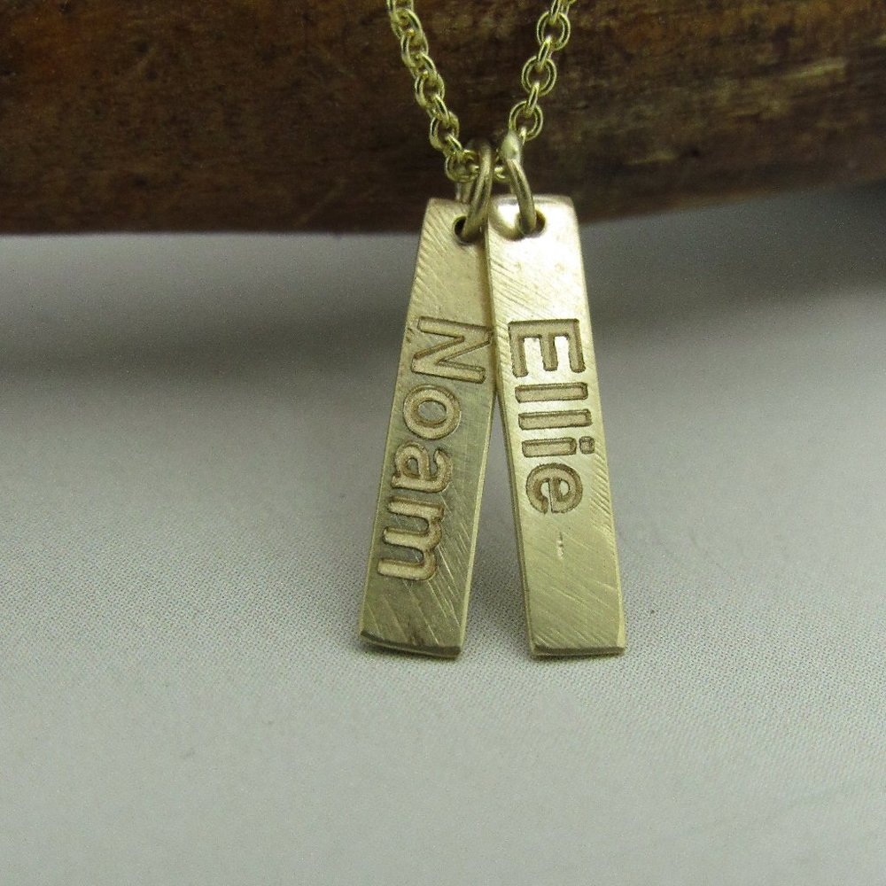 Name necklace. 14k Yellow gold necklace and 2 pendants with engraving.